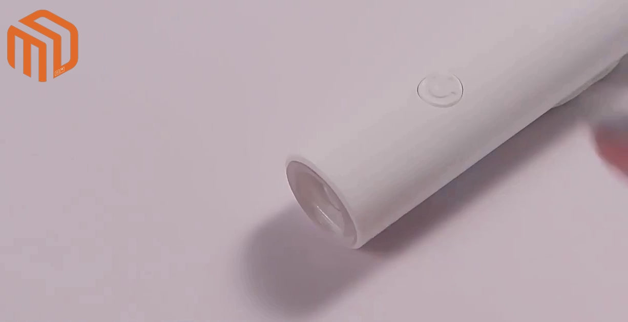 Handheld nail art LED lamp demonstration showing gel nail curing process