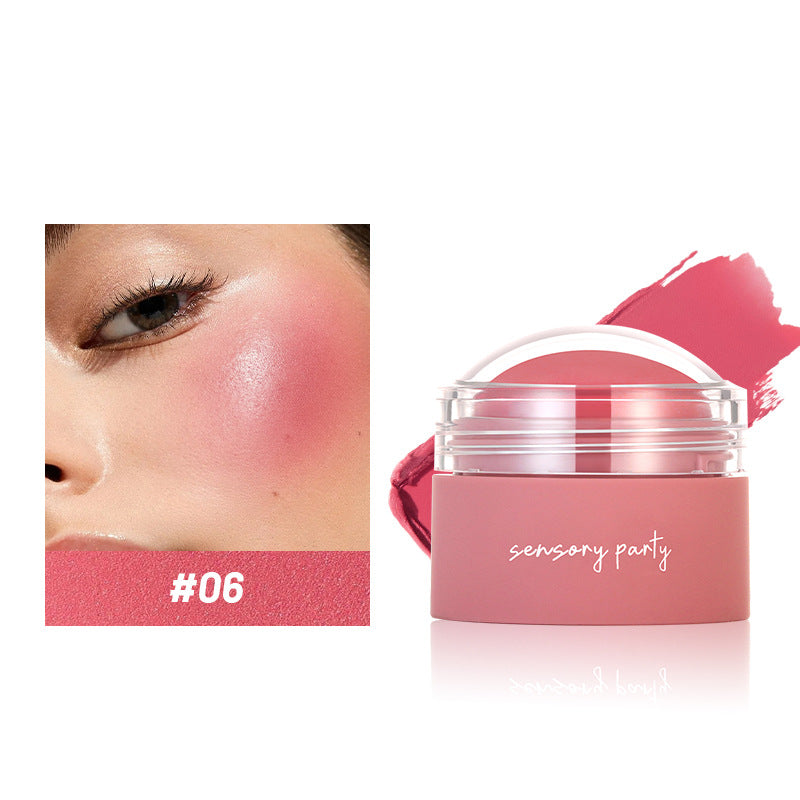 Pink blush on a woman's cheek with 'sensory party' product container.