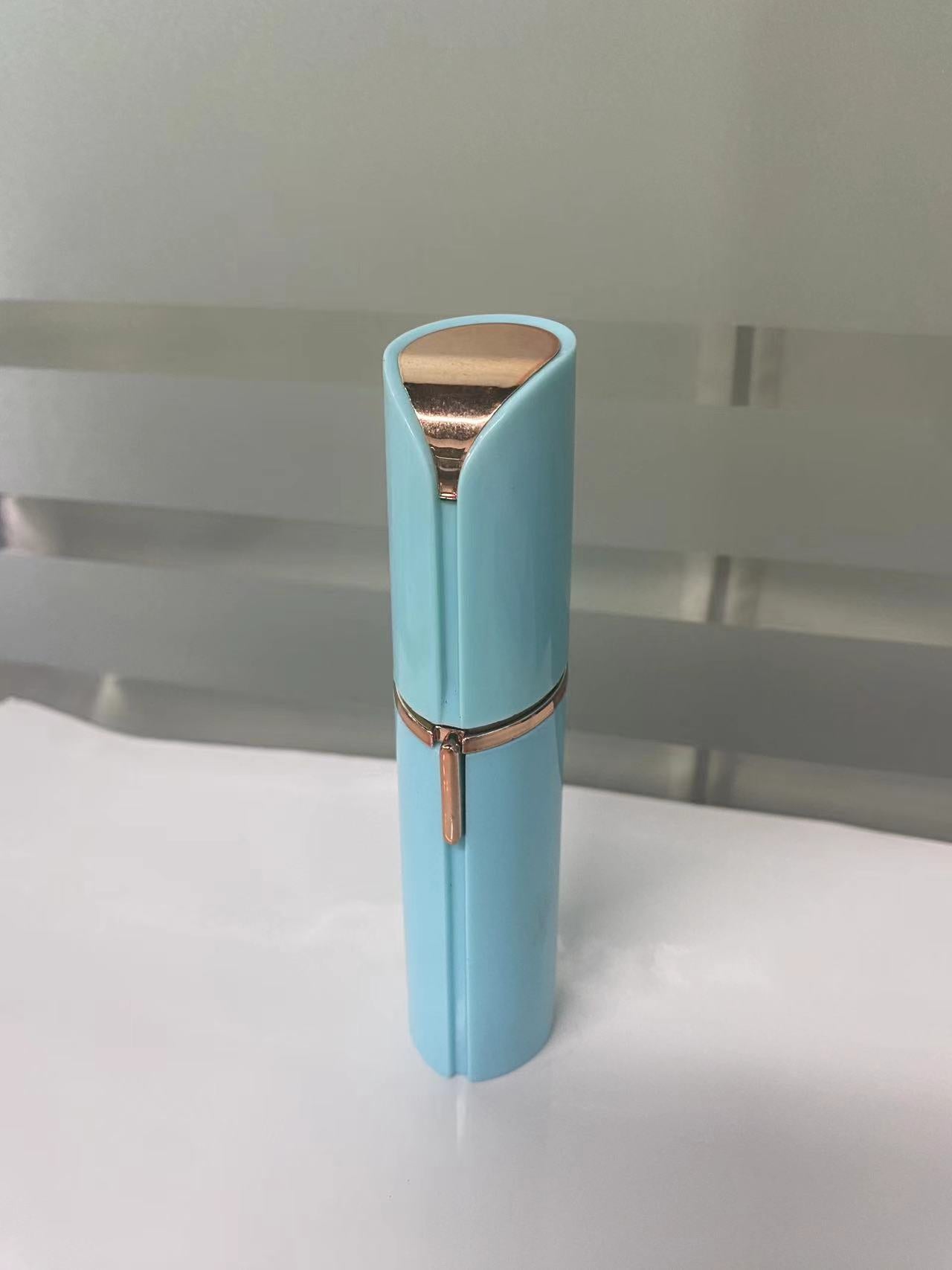 Light blue lipstick case with rose gold accents on a white surface.